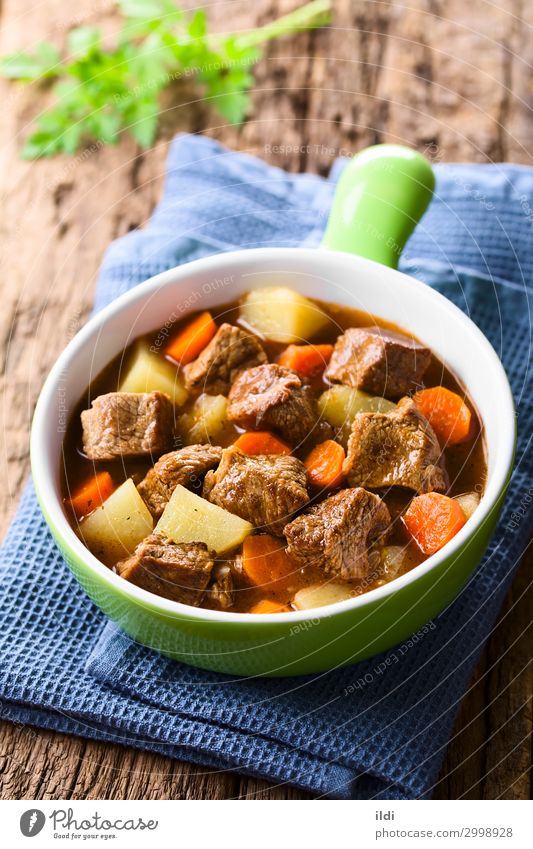 Beef Stew Meat Vegetable Soup Fresh food Carrot Potatoes Cooking Goulash Home-made Meal Dish paprika Hungarian gulyas gulyasleves diced served Vertical red bowl
