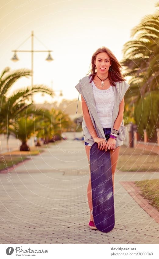 Young girl with a skateboard outdoors on summer Lifestyle Style Joy Happy Beautiful Leisure and hobbies Summer Sports Human being Woman Adults
