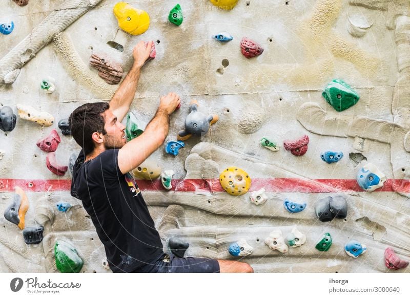 Man practicing rock climbing on artificial wall indoors. Lifestyle Joy Leisure and hobbies Sports Climbing Mountaineering Adults 1 Human being 18 - 30 years