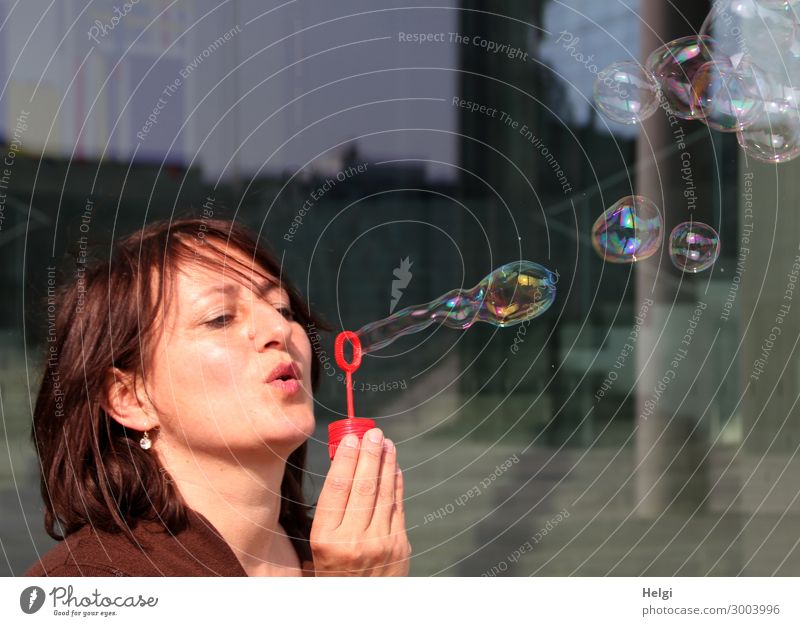 Woman with brunette long hair blows bubbles Human being Feminine Adults Head Hair and hairstyles Hand Fingers 1 45 - 60 years Soap bubble To hold on Exceptional