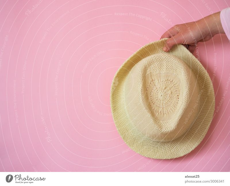 Hand holding hat on pink background with copy space Elegant Fashion Hat Pink Colour Beauty Photography cap Copy Space Glamor hot. photo isolated pastel Side