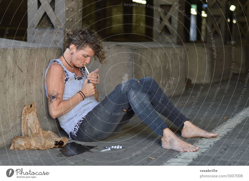 Drug addict punk kid sitting in the street lighting a cigarette Alcoholic drinks Smoking Intoxicant Unemployment Woman Adults 45 - 60 years Subculture Punk
