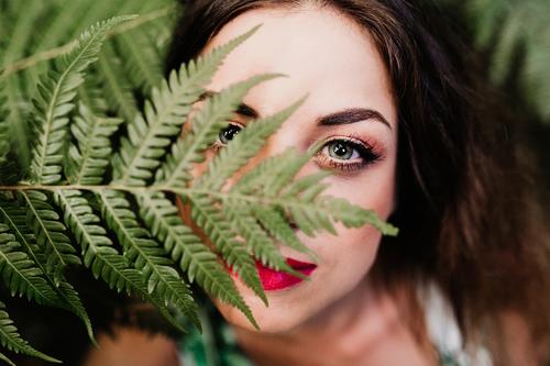 close up portrait of a young beautiful woman among green fern Lifestyle Beautiful Skin Face Make-up Wellness Spa Leisure and hobbies Garden Feminine Young woman