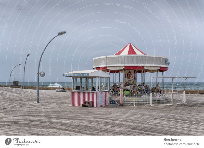 Merry-Go-Round in Tel Aviv Sky Clouds Waves Coast Ocean Mediterranean sea Port City Manmade structures Characters Beautiful Gray Red White Carousel Hobbyhorse