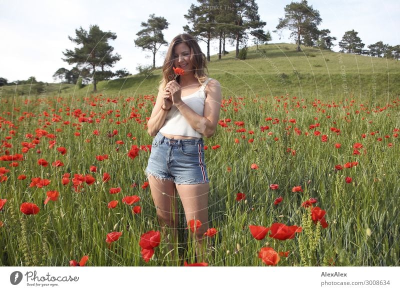 Young woman in poppy field Lifestyle Joy Happy Beautiful Harmonious Youth (Young adults) 18 - 30 years Adults Landscape Plant Flower Poppy Poppy blossom Field
