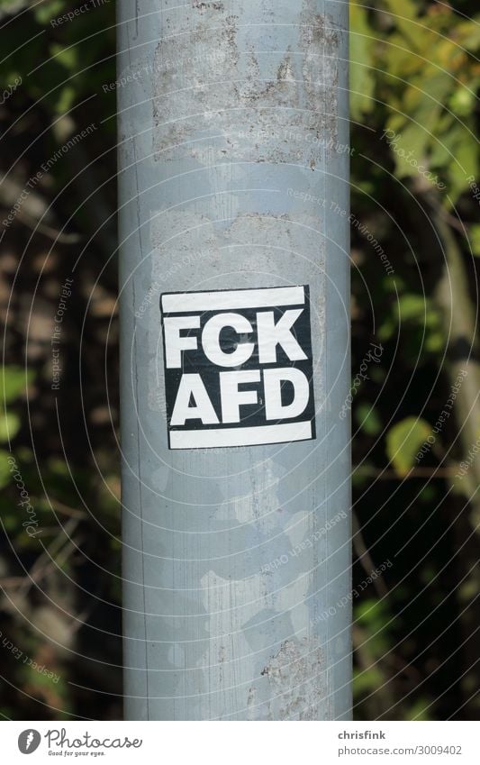 FCK AFD sticker on lantern pole Art Media Sign Characters Signs and labeling Signage Warning sign Communicate Aggression Rebellious Emotions Moody Acceptance