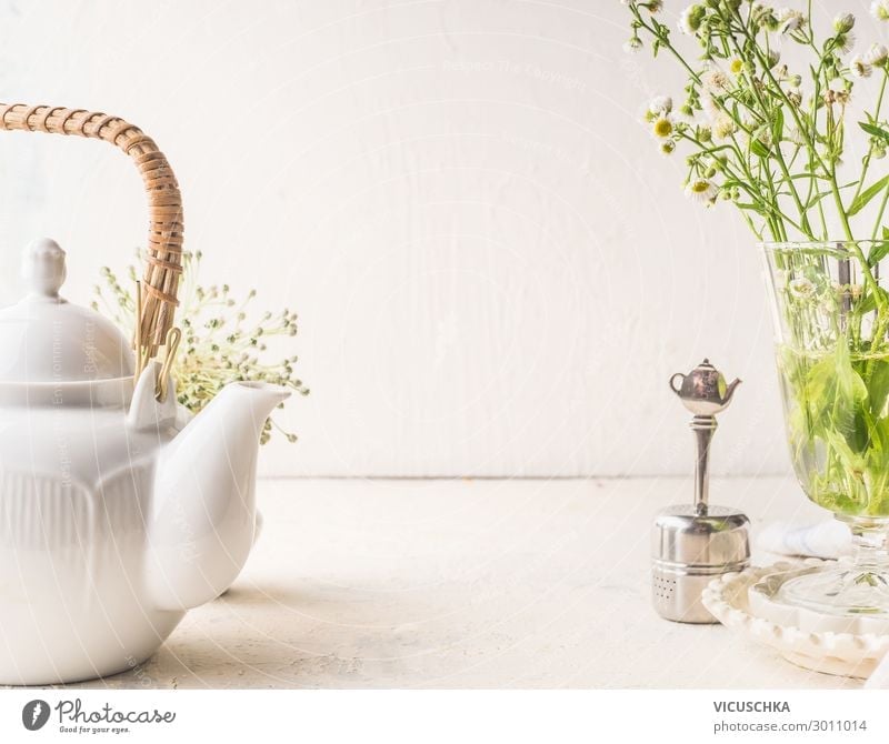 Teapot and tea strainer on a white table Food Beverage Hot drink Crockery Style Design Healthy Eating Living or residing Table Wall (barrier) Wall (building)