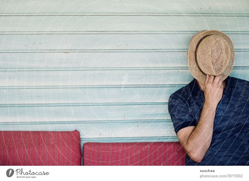 Man with hat Human being masculine Hat Unidentified without face Hide Seating Sofa Wooden wall Copy Space Striped Calm Relaxation rest Vacation & Travel