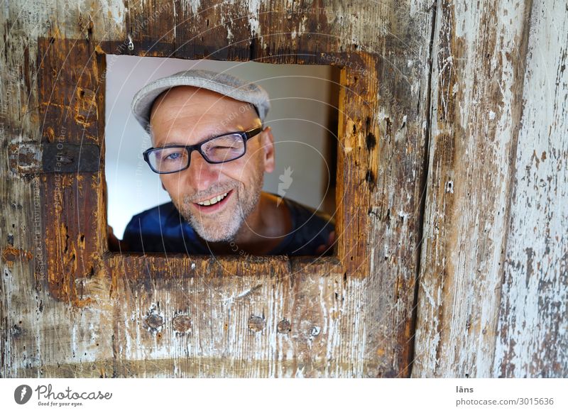 funny male portrait in wooden frame Human being Masculine Life 1 Wall (barrier) Wall (building) Eyeglasses cap Observe smile Looking Friendliness Happiness luck
