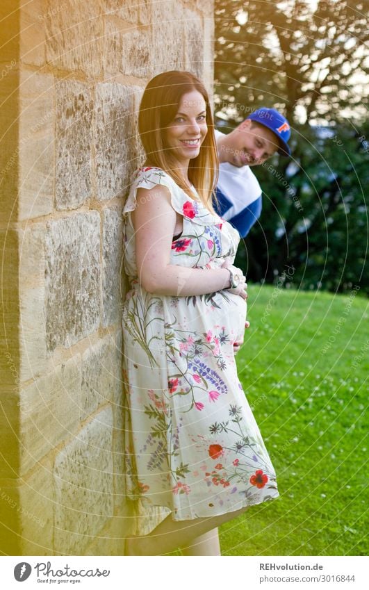 Pregnant woman and funny man at a wall - a Royalty Free Stock Photo from  Photocase