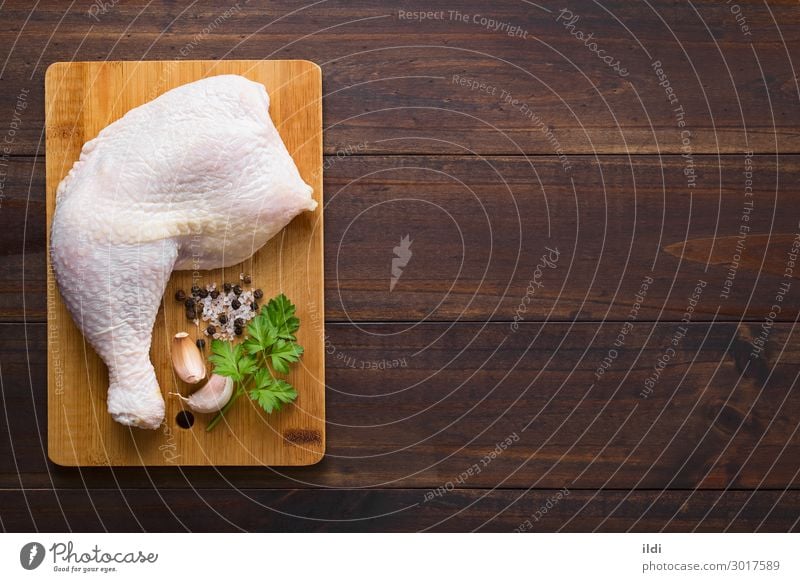 Raw Chicken Thigh Meat Fresh food poultry cooking leg part Protein board cutting wood seasoning salt pepper Garlic Parsley Copy Space Top overhead Horizontal