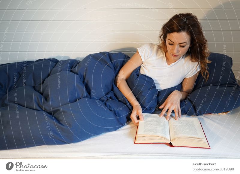 young woman reads a book in bed Bed Bedroom Book Reading Lie Leisure and hobbies Lifestyle Relaxation Living or residing Flat (apartment) Entertainment