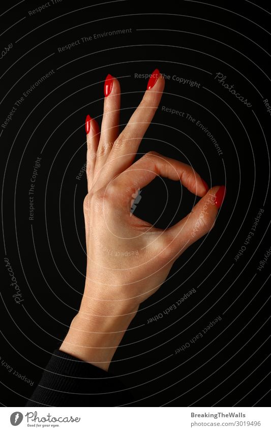 Woman hand with okay gesture over black Human being Feminine Young woman Youth (Young adults) Adults Hand Fingers 1 Good Red Black Joy Self-confident