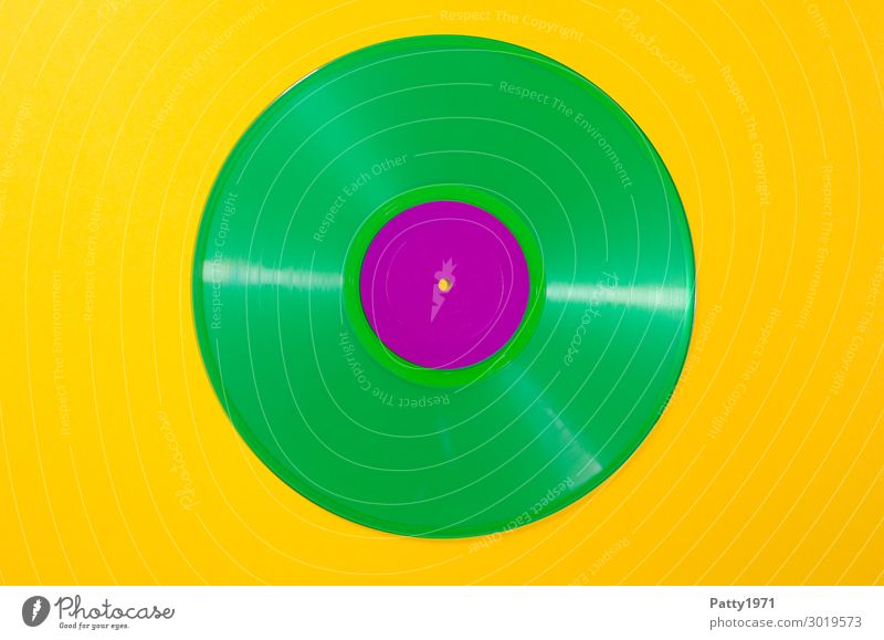Vinyl record in green vinyl against a neutral yellow background Music Listen to music Record Hip & trendy Retro Round Crazy Yellow Green Violet Colour