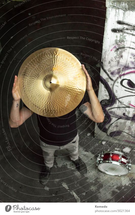 Drummer man with cymbal on his head in dark urban place. Lifestyle Joy Athletic Wellness Leisure and hobbies Playing Handcrafts Freedom Interior design Room