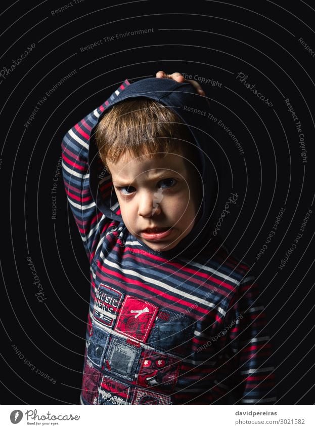 Angry boy with hoodie over black background Face Child Human being Boy (child) Man Adults Infancy Stand Sadness Authentic Dark Small Cute Crazy Anger Black
