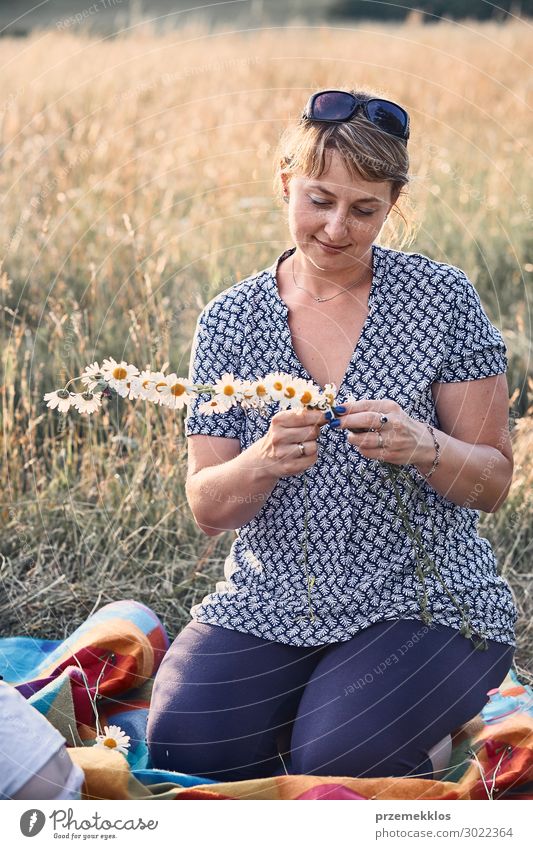 Woman making coronet of wild flowers Lifestyle Joy Happy Relaxation Leisure and hobbies Vacation & Travel Summer Summer vacation Child Human being Young woman