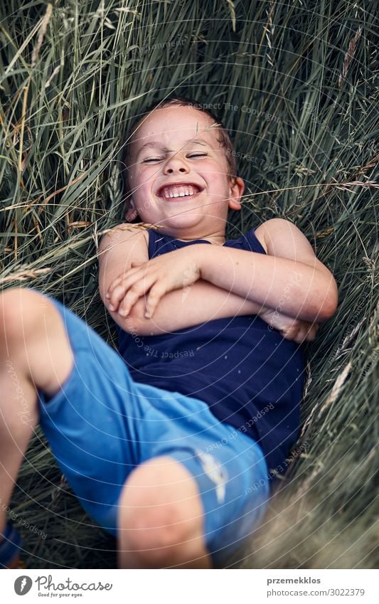 Little happy smiling boy playing in a tall grass Lifestyle Joy Happy Relaxation Vacation & Travel Summer Summer vacation Child Human being Boy (child) 1