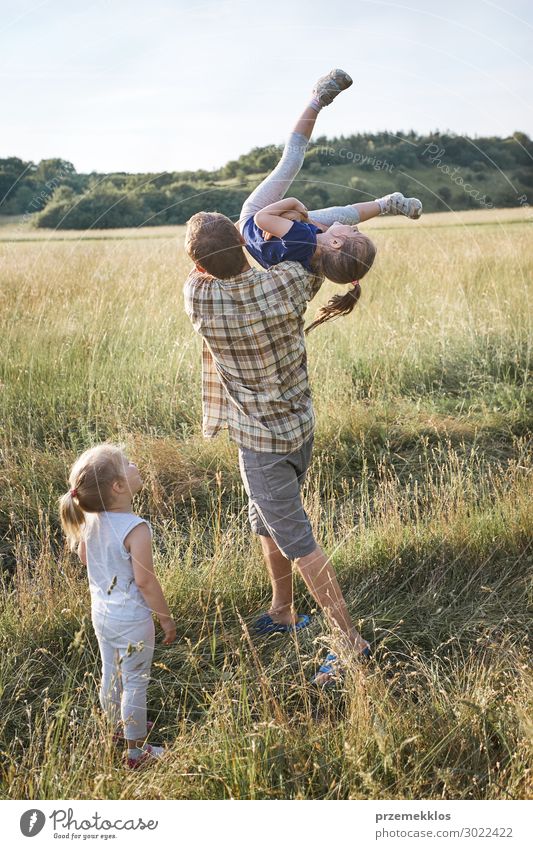 Father tossing little girl in the air Lifestyle Joy Happy Relaxation Vacation & Travel Summer Summer vacation Child Human being Girl Boy (child) Woman Adults
