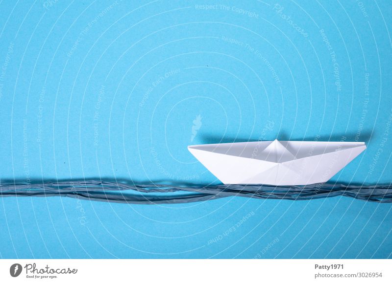 Paper ship on a blue background and blue cord, representing the waves Paper boat Blue White Calm Contentment Serene smooth Swell relax Boredom Tourism Logistics