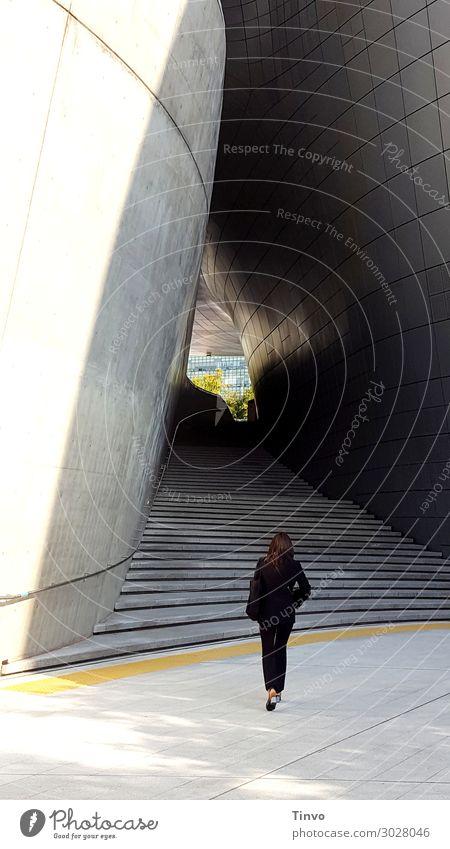 Woman in front of staircase / passageway Feminine Adults 1 Human being Manmade structures Architecture Stairs Going Gray Black Business Resolve Target Passage