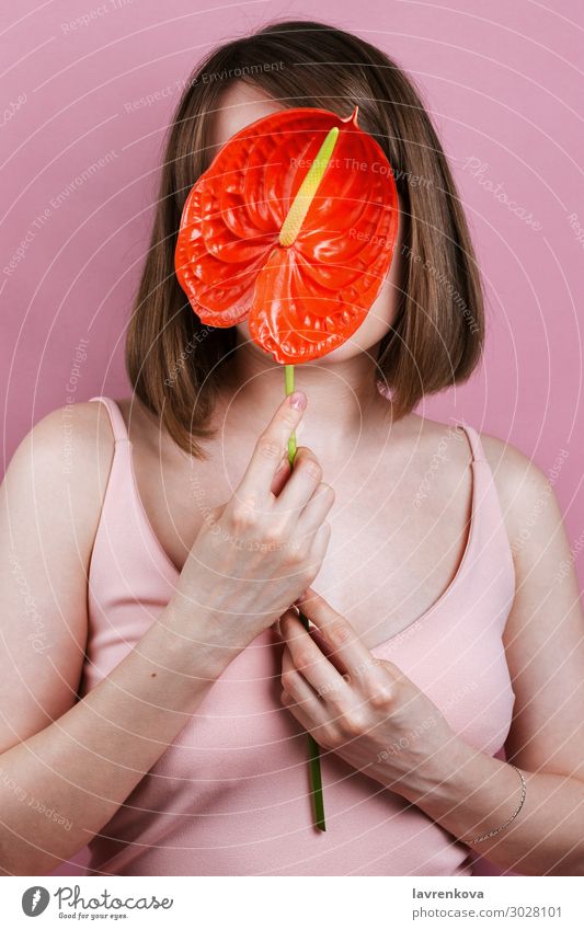 Woman's holding red peace lilly bloom Spatiphyllum Beauty Photography Body care Faceless Fashion Fingers Flower Hand Lily Love Pink Red sensual Eroticism Style