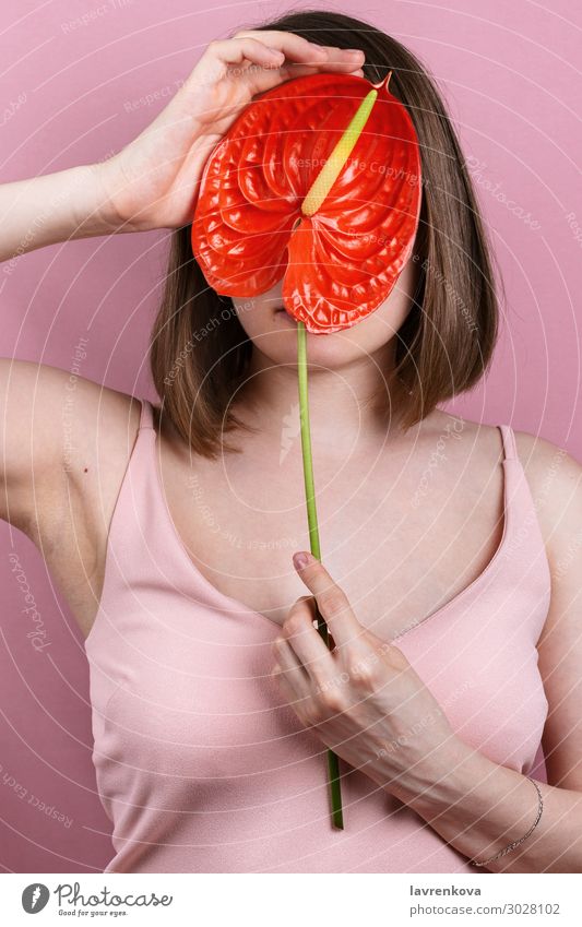 woman in pastel pink dress holding bright red bloom peace lilly Beauty Photography Body care Faceless Fashion Woman Fingers Flower Hand Lily Love Pink Red