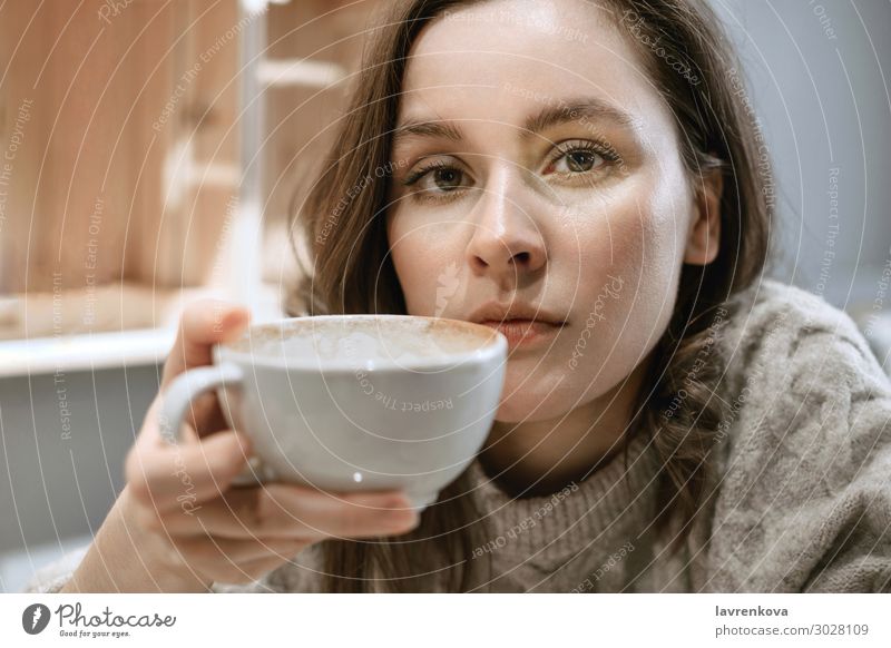 Young adult white woman with big cup of latte Restaurant Sweater Seasons Beverage Hot hygge Hold Tea Face Cup Mug Lifestyle Woman Young woman