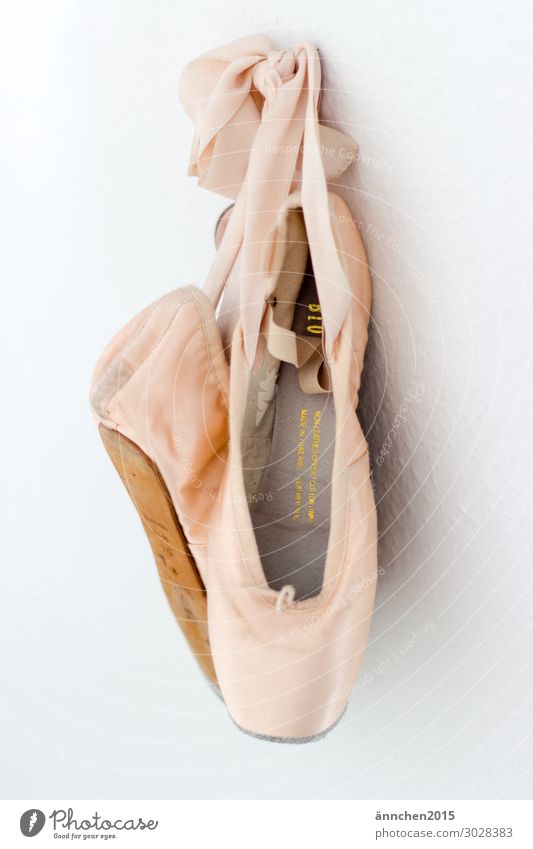 Pink lace shoes hanging on a white wall ballet Dance Footwear pointe shoes Dancer Ballerina Colour photo Classic Elegant already pose Ballet practice exercise