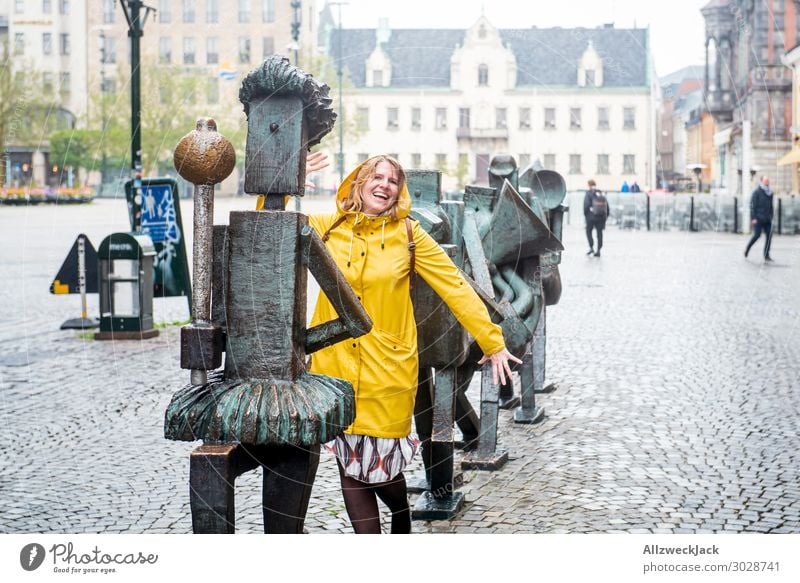 young woman in yellow rain jacket marches with Sweden Malmo 1 Person Central perspective Downtown Old town Bad weather Rain Young woman Joy Playing Dance March