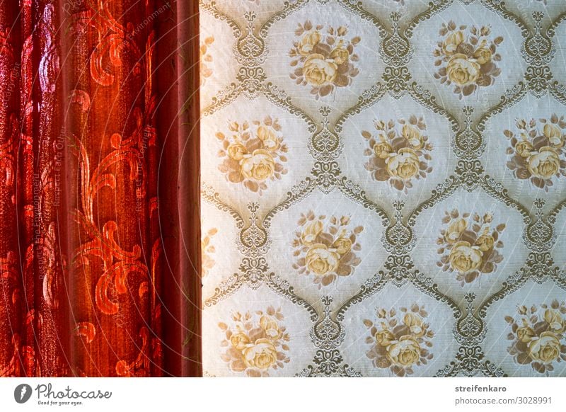 Red curtain with flower pattern approaches a patterned wallpaper Living or residing Flat (apartment) Interior design Room Wallpaper Wallpaper pattern Drape