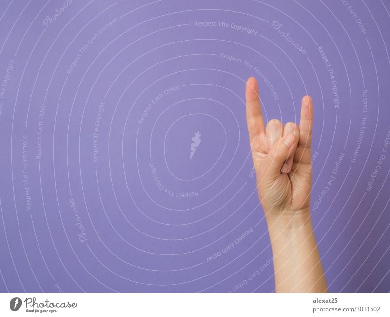 Female hand shows sign "devil" on purple background Music Human being Arm Hand Fingers Rock Metal White Conceptual design conceptual Copy Space Devil Evil