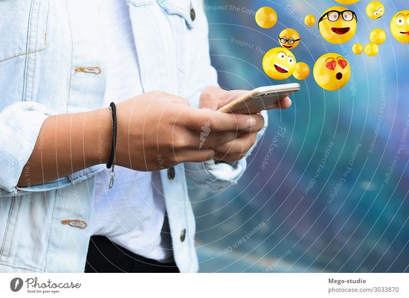 Woman using smartphone sending emojis. Lifestyle Happy Face Telephone PDA Screen Technology Internet Human being Adults Hand Funny Modern Smart Emotions young