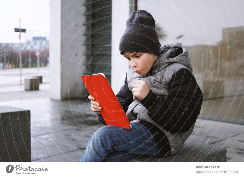 Boy with Tablet Computer Lifestyle Joy Leisure and hobbies Playing Computer games Winter Entertainment Notebook Technology Entertainment electronics Internet