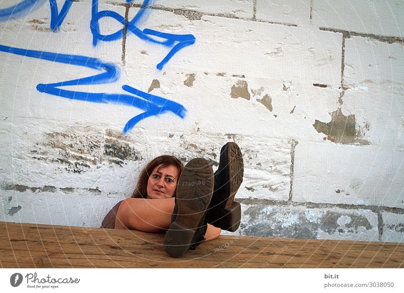 Woman leans against a wall and puts her feet up. Well-being Senses Relaxation Calm Meditation Vacation & Travel Tourism Trip Adventure Feminine Adults