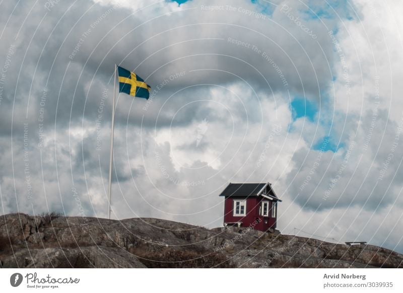 A small hut next to Swedish flag Lifestyle Vacation & Travel Tourism Summer Ocean Island House (Residential Structure) Architecture Landscape Air Sky Clouds