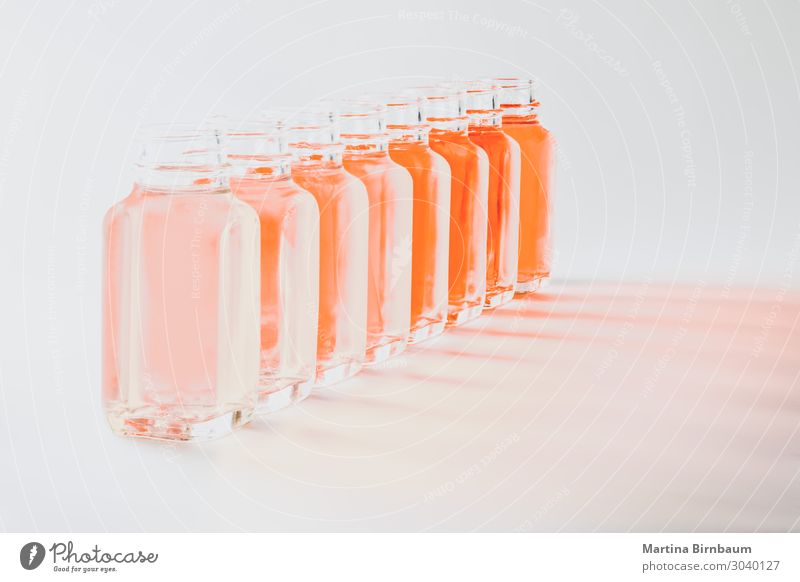 Bottles with coral colored fluids in different shades Vegetable Fresh Wet Brown Pink White Coral isolated living background orange palette water liquid