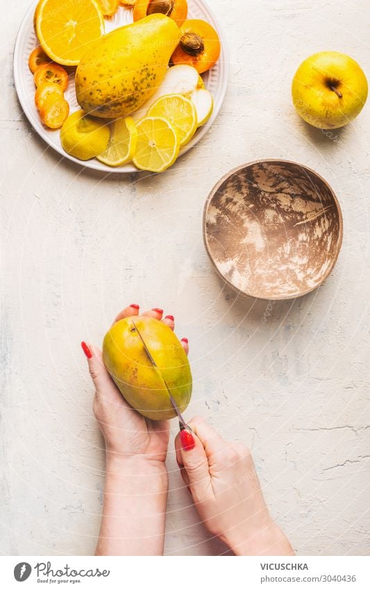 Mango preparation step 1. female hands cut mango Food Fruit Nutrition Organic produce Vegetarian diet Diet Crockery Knives Design Healthy Eating Hand Yellow