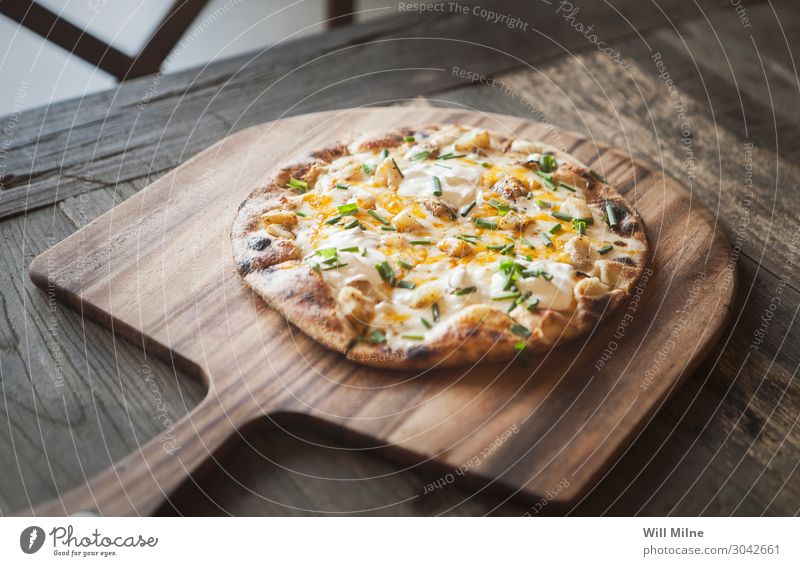 A freshly baked pizza on a wooden tray. Food Cheese Dough Baked goods Eating Lunch Fast food Italian Food Pizza Restaurant Fresh Baked dish Stove & Oven