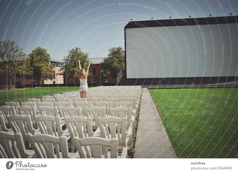 movie theater Cinema open-air cinema film screening Exterior shot Chair Seating 1 Person Human being Girl Youth (Young adults) Young woman Applause Expectation