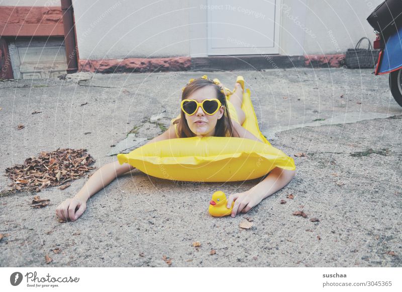 girl on yellow air mattress in the autumnal backyard | dry swimmer Summer Autumn flaked Longing Vacation & Travel Swimming & Bathing Air mattress Squeak duck