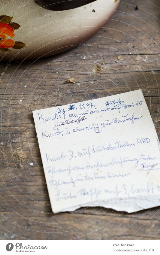 Handwritten old note next to cooking pot on old kitchen table Food Soup Stew Garlic Nutrition Lunch Pot Flat (apartment) Wood Write Old Poverty Dirty Delicious