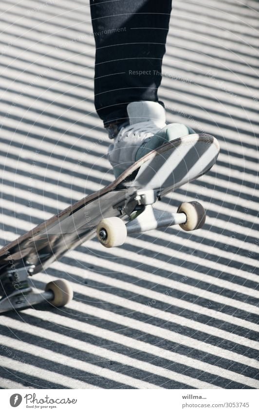 Foot on a skateboard, with diagonal shadows, quite oblique Skateboard Feet wheel Roll Sneakers Shadow obliquely Diagonal Stripe Skateboarding