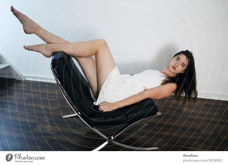 Young woman lying upside down on an armchair Lifestyle Style Joy Beautiful Living or residing Armchair Youth (Young adults) Legs Feet 18 - 30 years Adults Dress