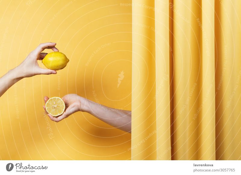 Two women's hands holding cut and whole lemons Natural Yellow Fingers Hold Hand Healthy Healthy Eating Vitamin C Lemon Citrus fruits Fruit Conceptual design