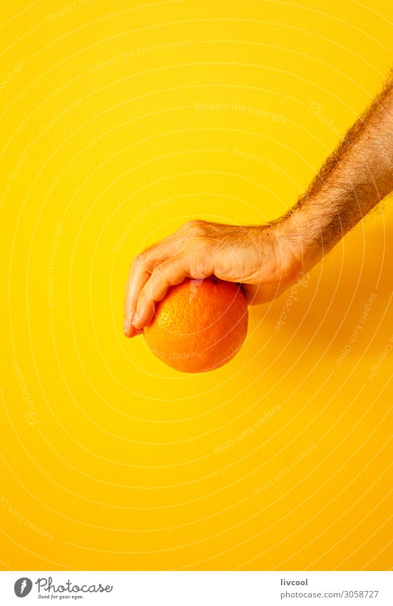 orange in hand on yellow wall II Fruit Lifestyle Design Human being Man Adults Arm Hand Fingers Nature To enjoy Fresh Yellow Colour people Illustration