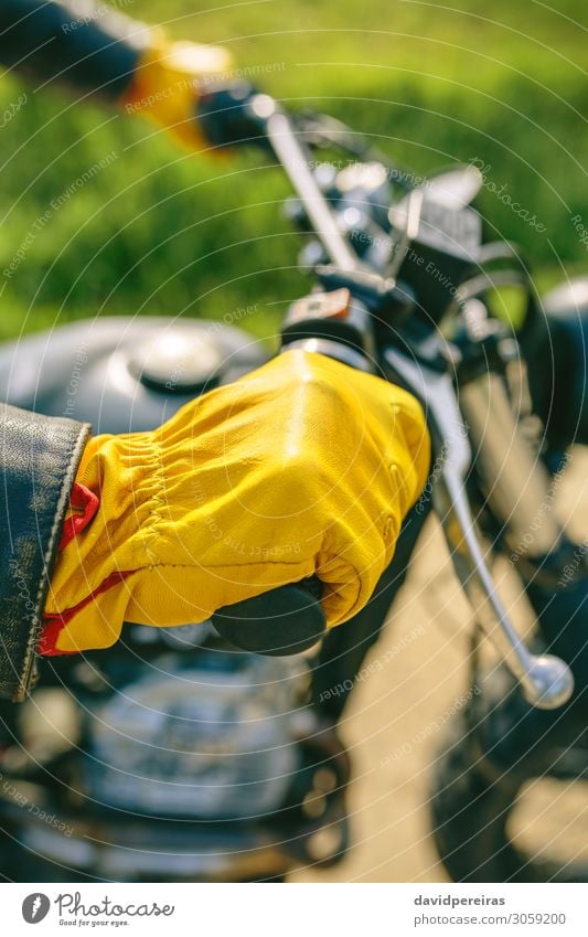 Biker's hand with gloves grabbing the handlebar Lifestyle Engines Human being Man Adults Hand Grass Transport Street Vehicle Motorcycle Gloves Authentic Retro
