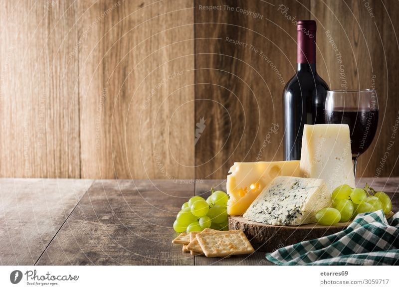 Assortment of cheeses and wine on wooden table. Cheese Wine Food Healthy Eating Food photograph Beverage Alcoholic drinks assortment Wood Bottle french Gourmet
