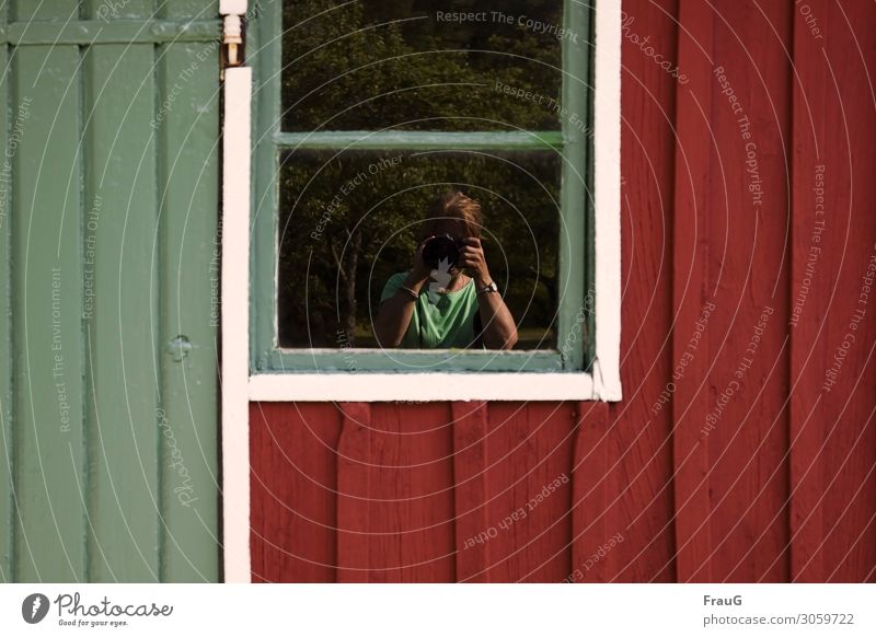 Selfi in window Wall (building) Facade Wood Building Window reflection trees taking a photograph Woman camera hands face concealed Clock Bracelet Chain Red