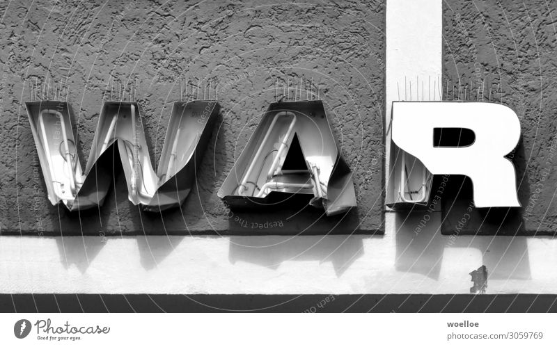 War or the past? Wall (barrier) Wall (building) Facade Neon sign Concrete Glass Metal Characters Signs and labeling Word Wordplay Broken Letters (alphabet)